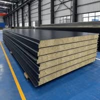 Stack of black-faced SAMAN rockwool sandwich panels in the factory