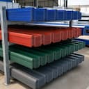 Stack of colour-coated roofing sheets in multiple colours at SAMAN supply yard
