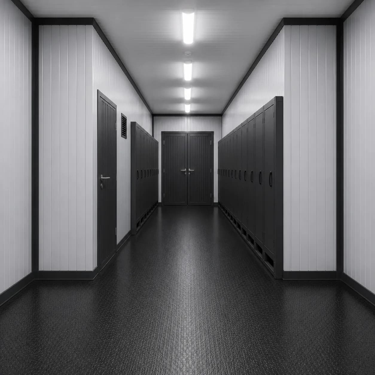 40 ft high cube BESS enclosure interior facing the closed double end doors, cabinets each side of the aisle