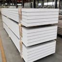 Stack of SAMAN steel-faced EPS sandwich panels with visible white EPS core