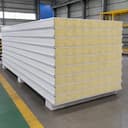 Stack of SAMAN glass wool panels showing fibrous core and steel facings