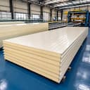 Stack of 50 mm off-white PUF panels at the factory