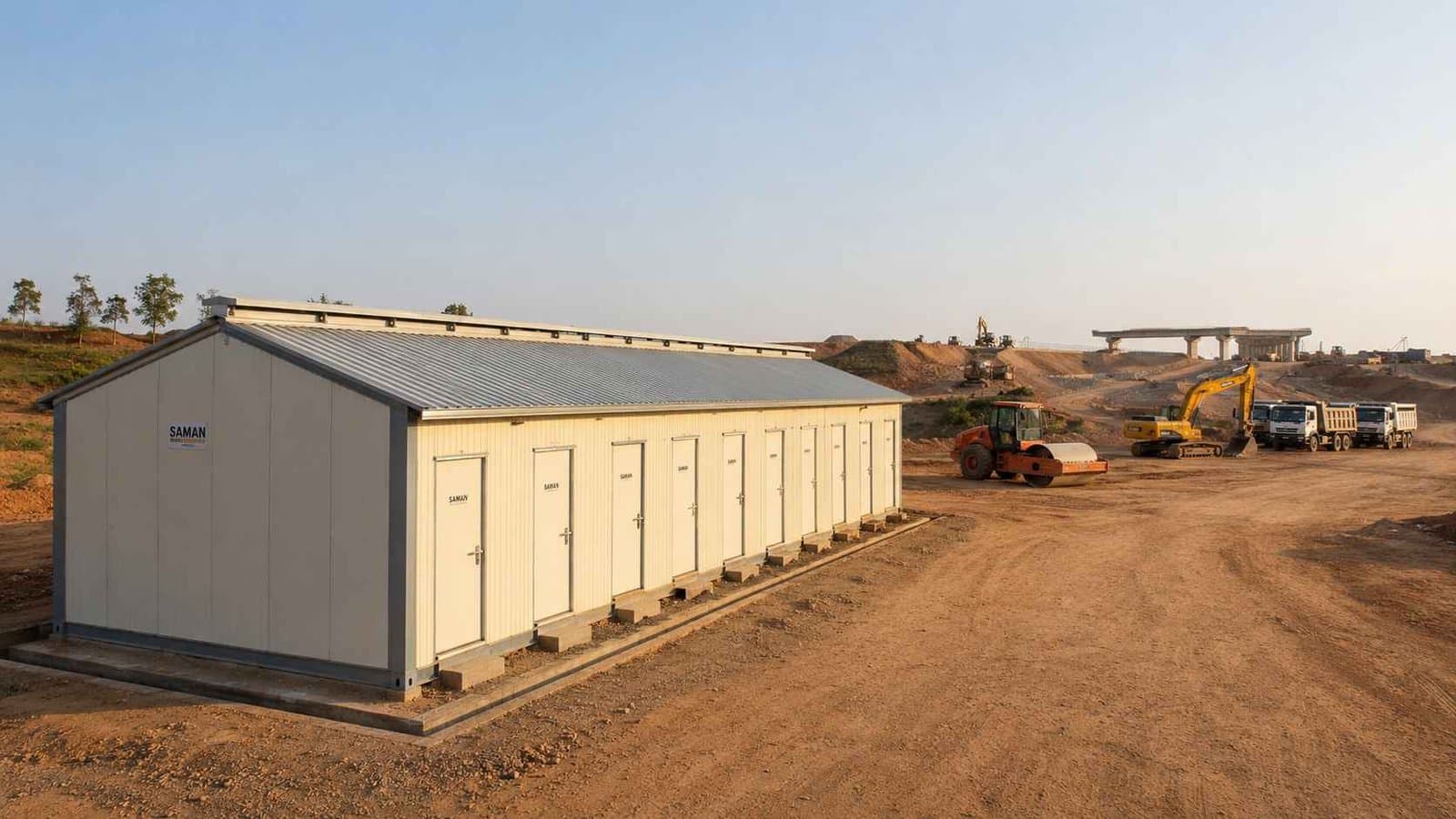 SAMAN labor shed deployed at a highway construction project site in India with road equipment in the background