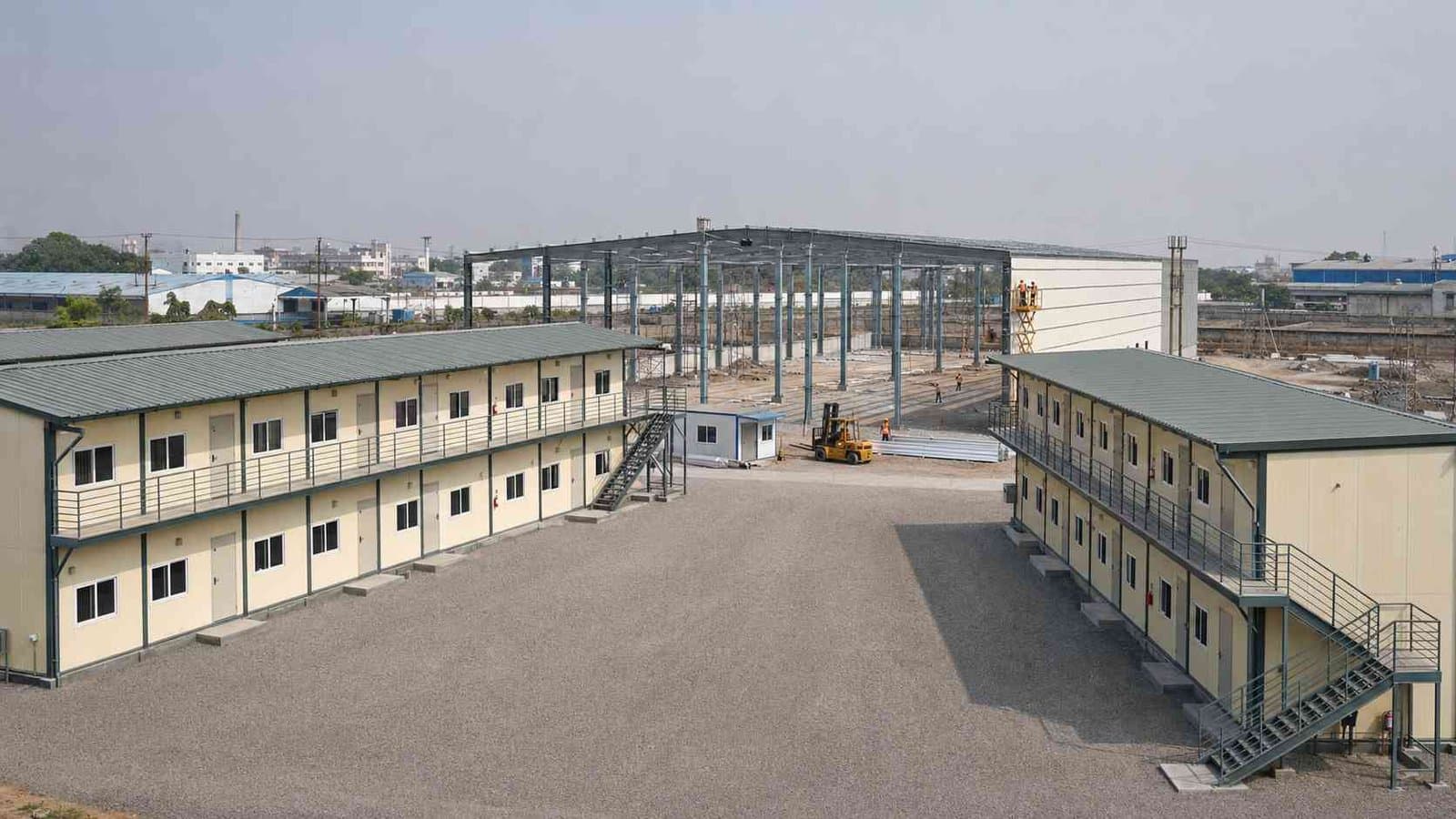 Two G+2 SAMAN labor shelter blocks at a factory-expansion warehouse construction project in India