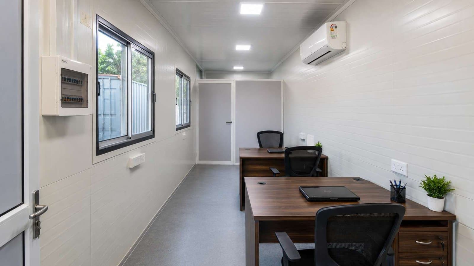 Portable office cabin interior with workstation, MD cabin partition, split AC, and LED panel lights.