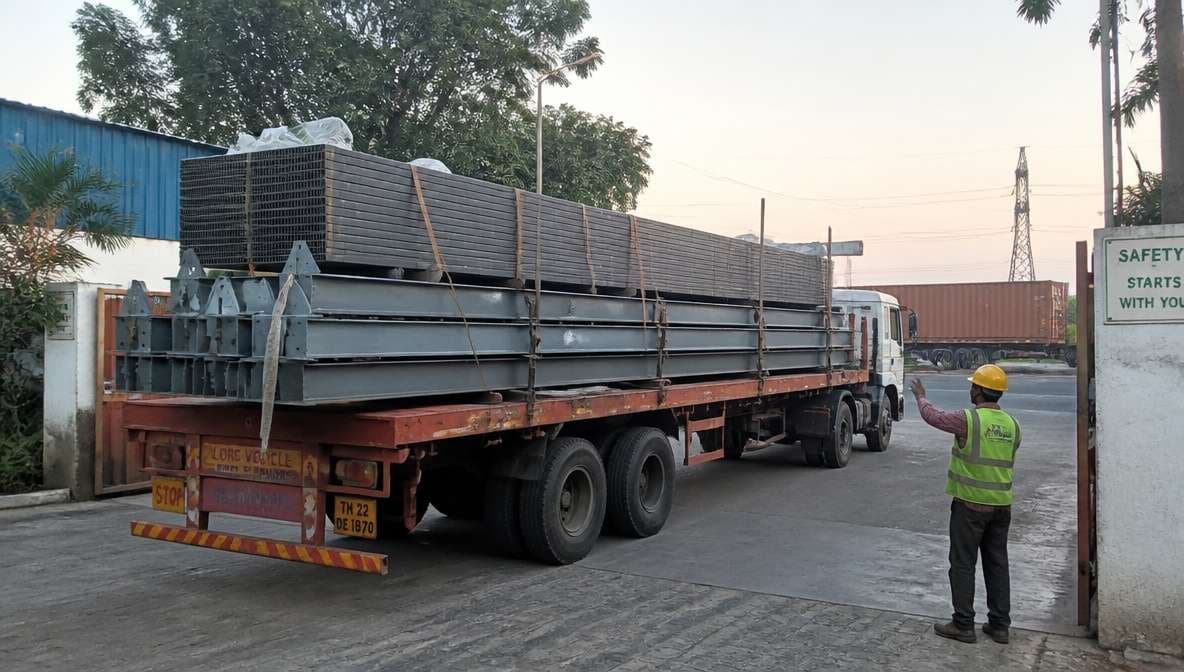 Truck loaded with prefab building steel members and panels dispatched from a SAMAN plant.
