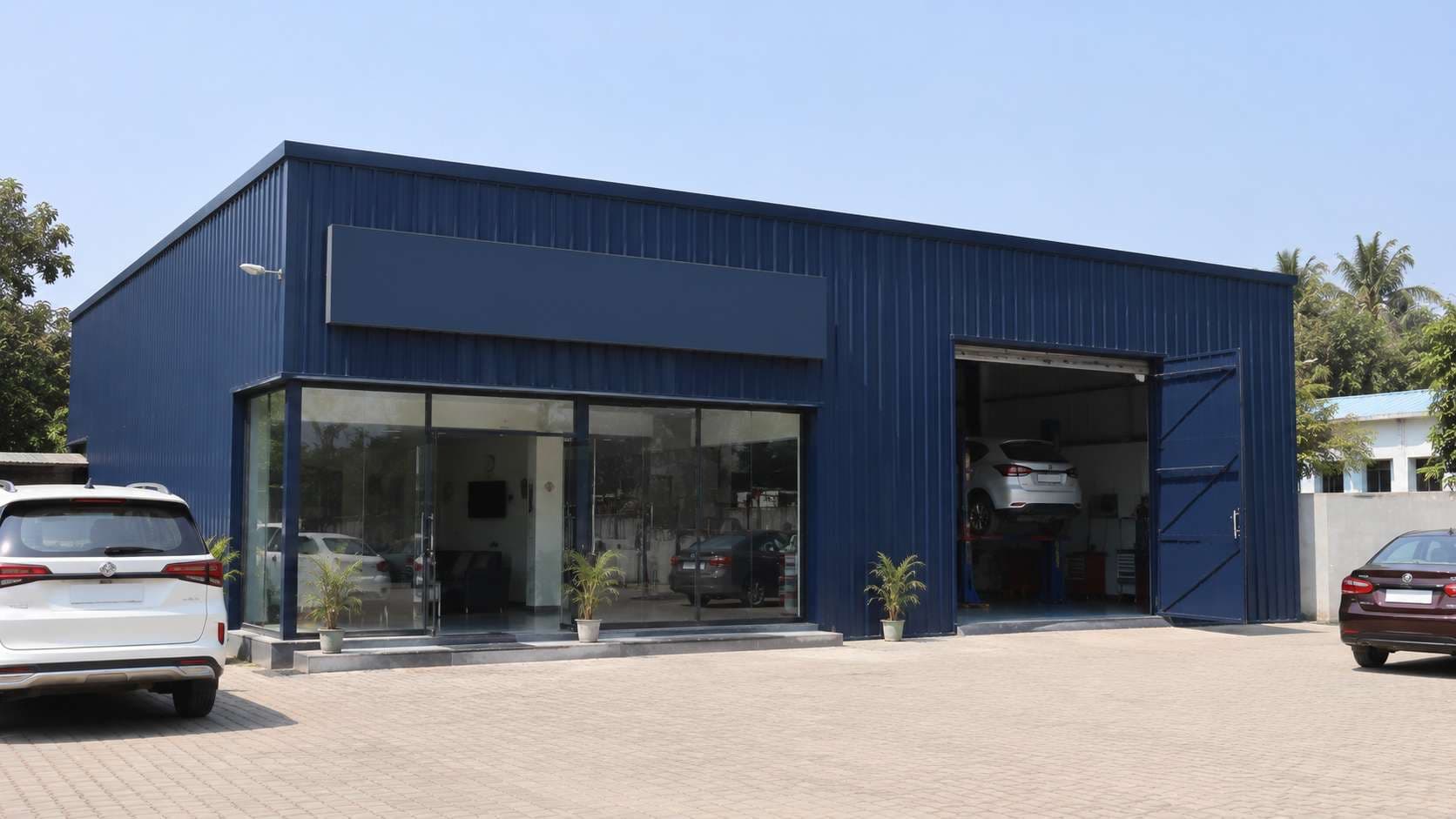 Navy prefab commercial building used as a service centre with a glazed reception and a work bay.