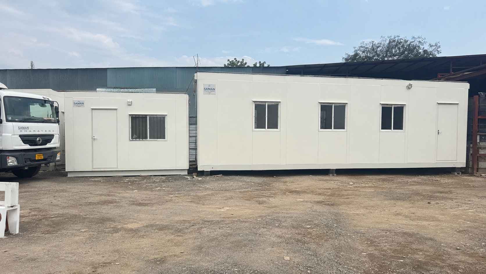 A white prefab site office beside a larger bunkhouse in SAMAN's prefab range.