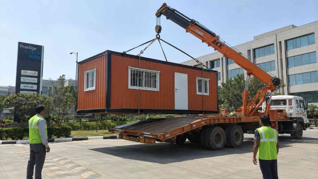Brick Terracotta mobile office unit being unloaded by crane at an Indian tech-park premises