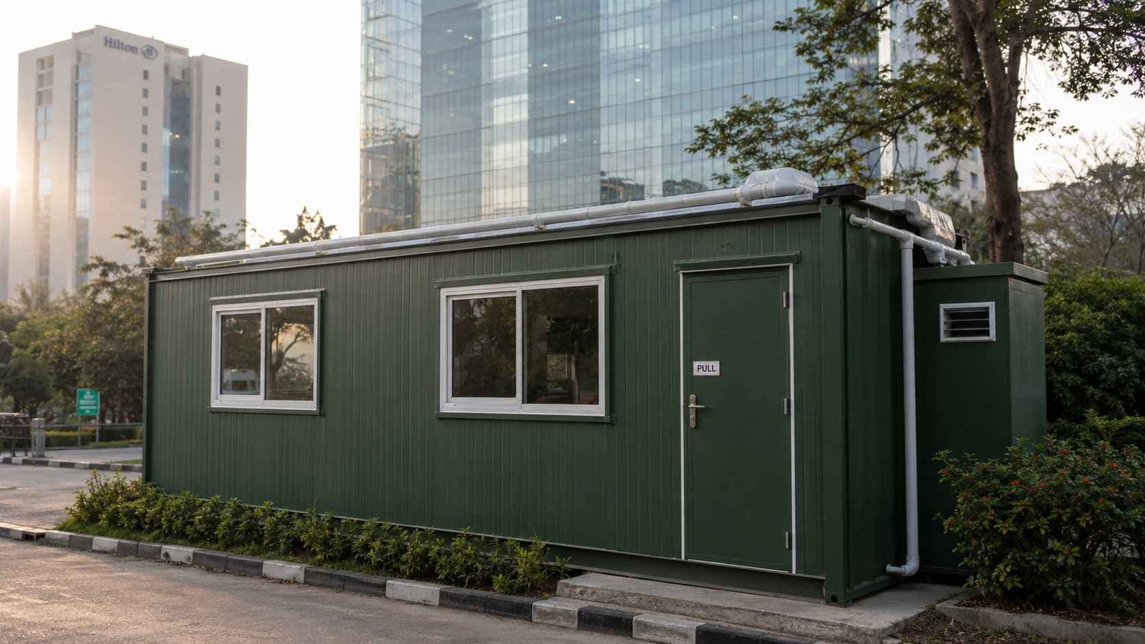 Forest Green SAMAN multi-room porta cabin at an Embassy Golf Links–style tech-park perimeter in Domlur, Bangalore.