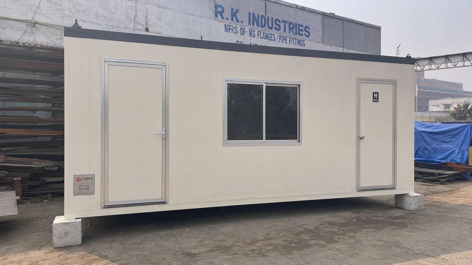 Cream White 10×20 ft porta cabin office with attached toilet — typical Delhi site office configuration.
