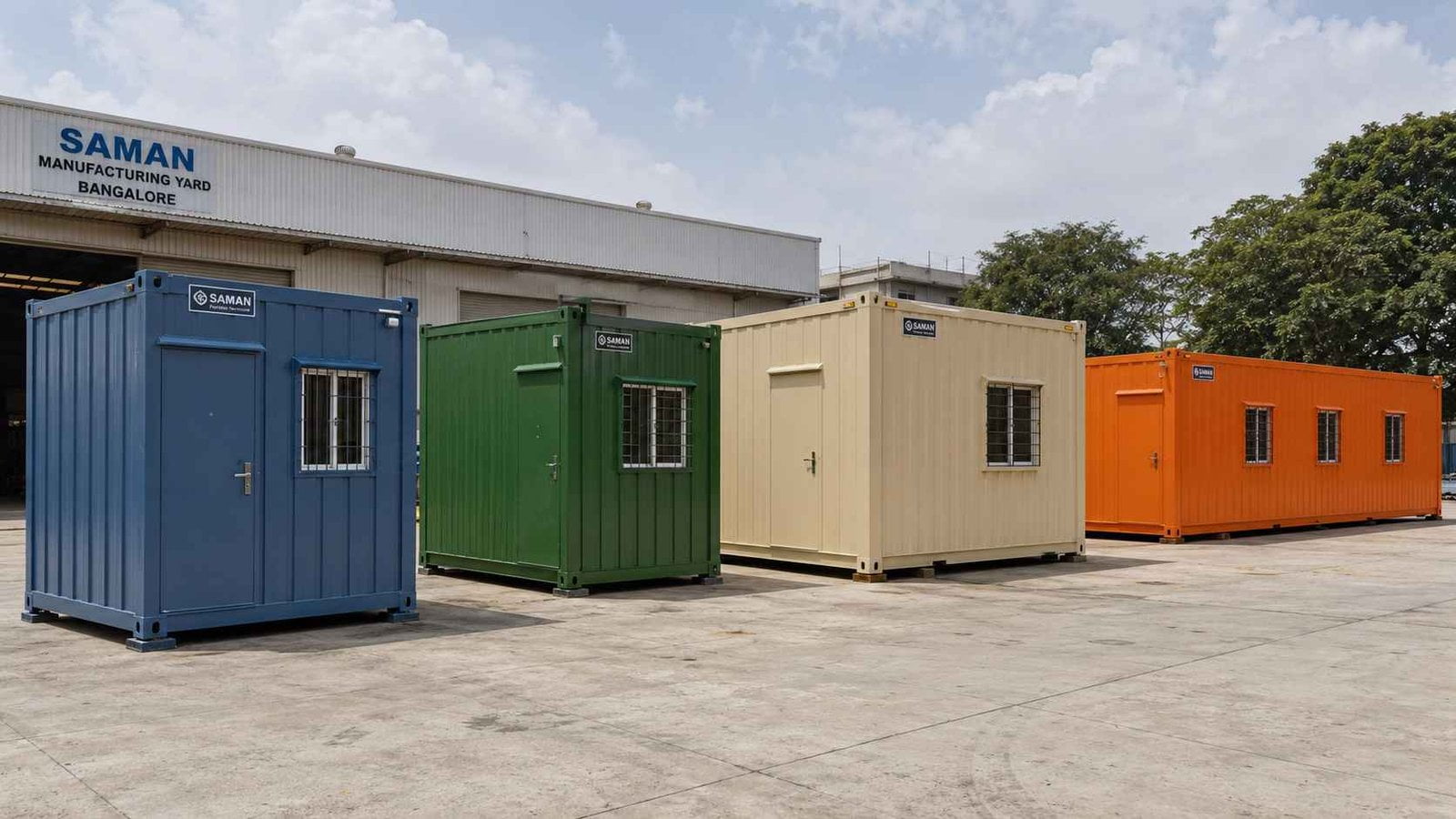 Four SAMAN porta cabins lined up by size at the Bangalore factory yard, from 10×10 ft Steel Blue to 35×11 ft Safety Orange.