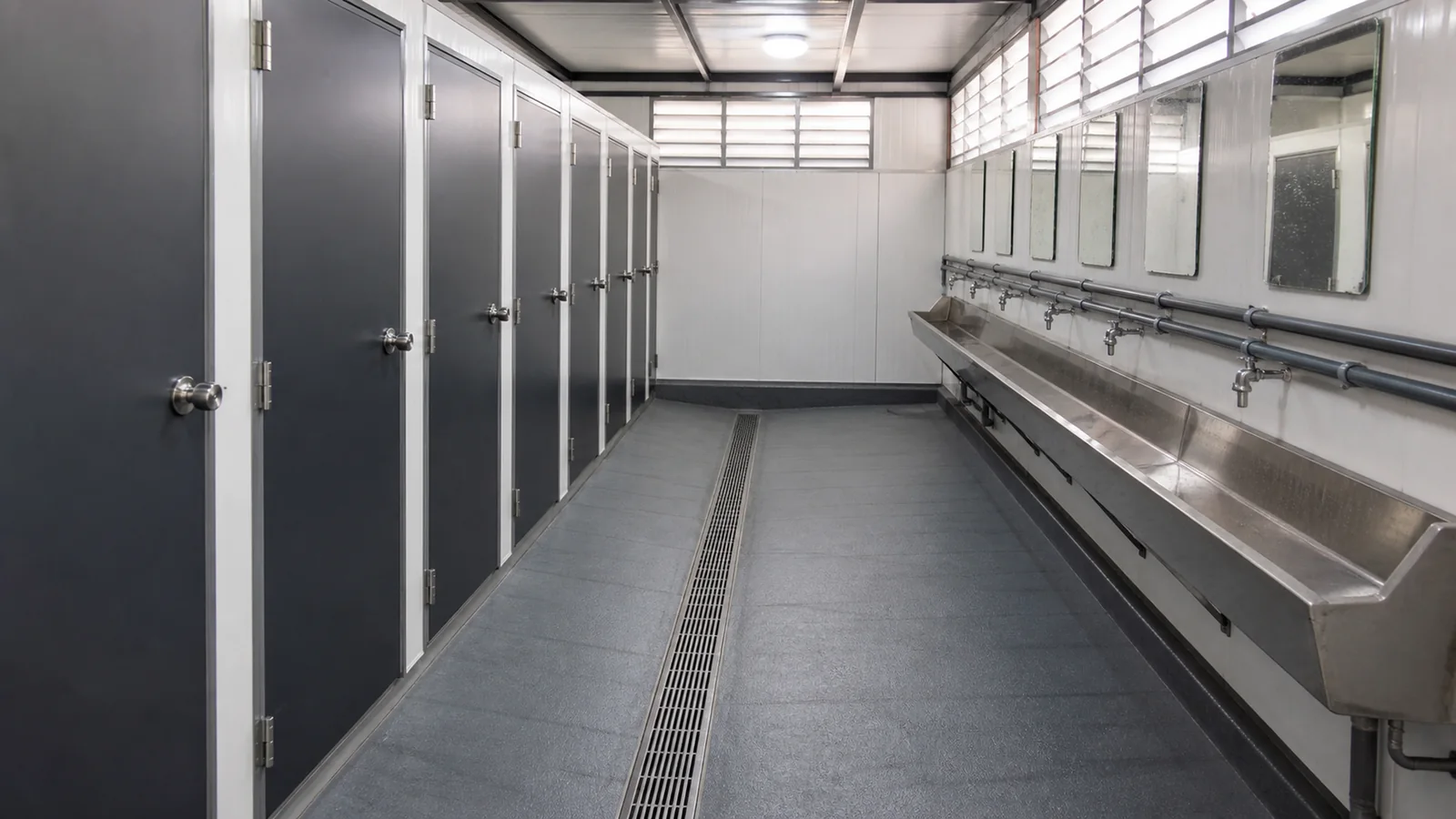 Interior circulation route with the cubicle bank on one side and the wash run opposite