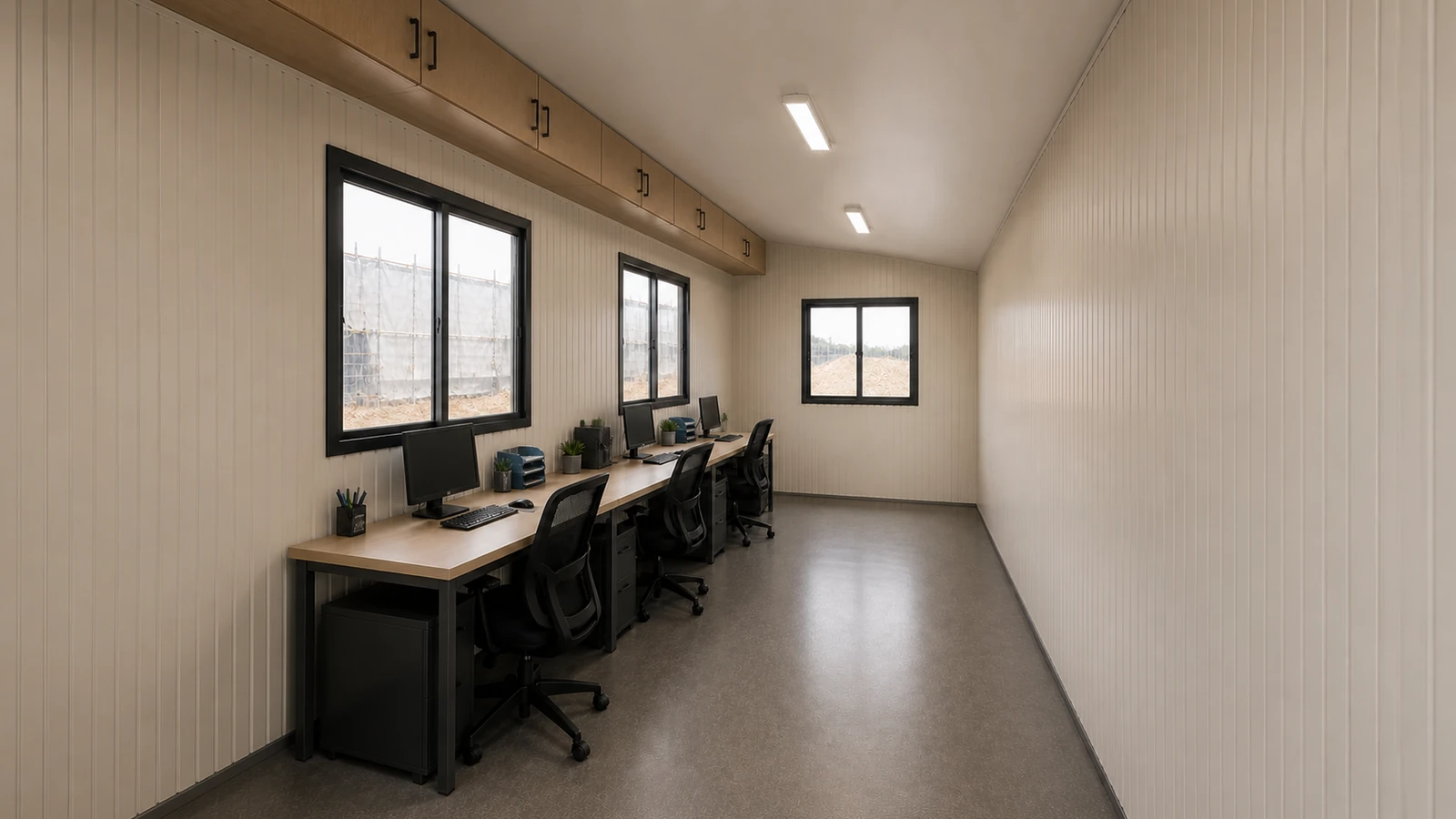 Interior of a 20 × 8 ft site office cabin, three desks in one run under the rear windows