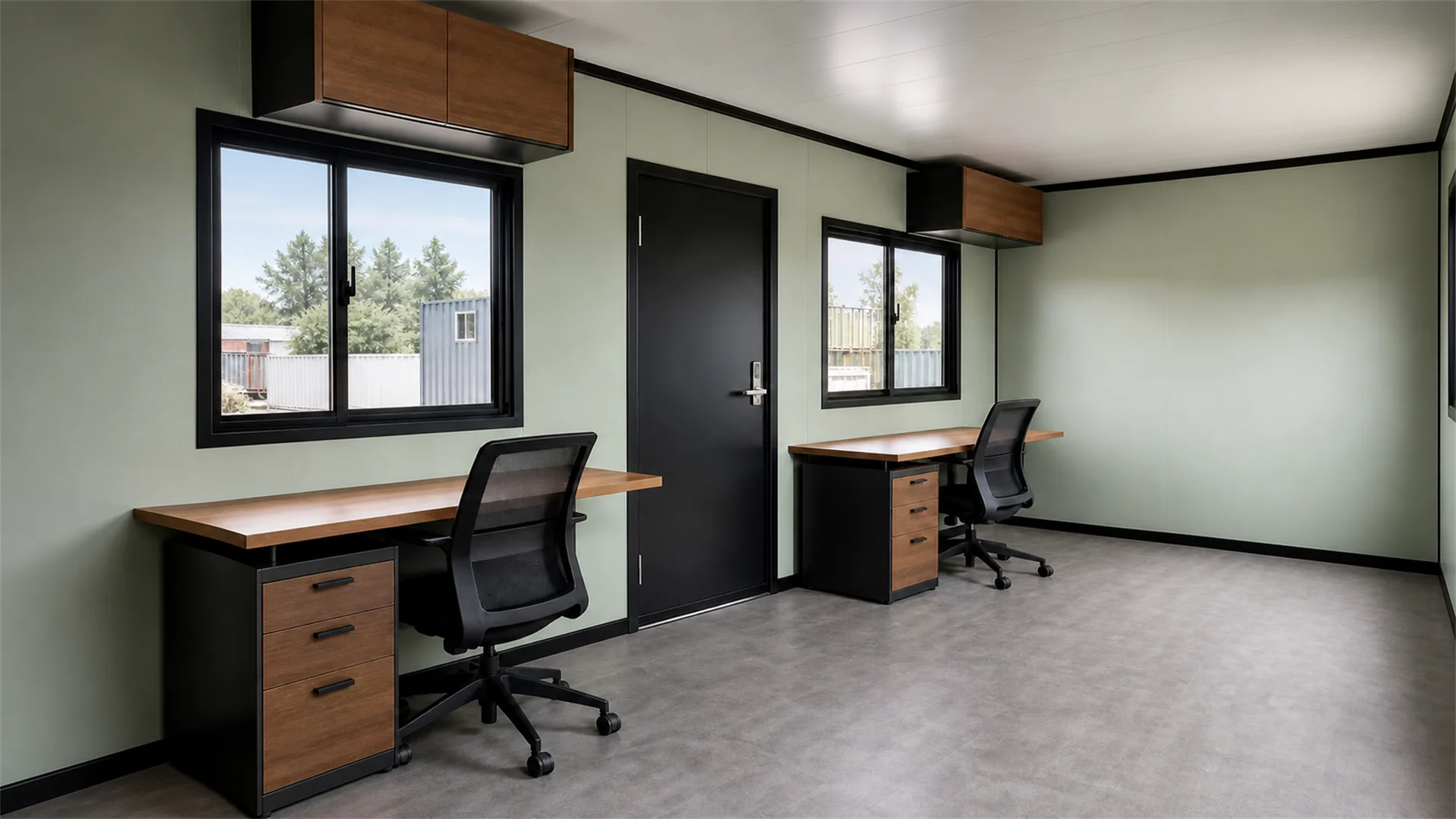 Container office interior with two desks, drawer pedestals, a black entry door and two sliding windows