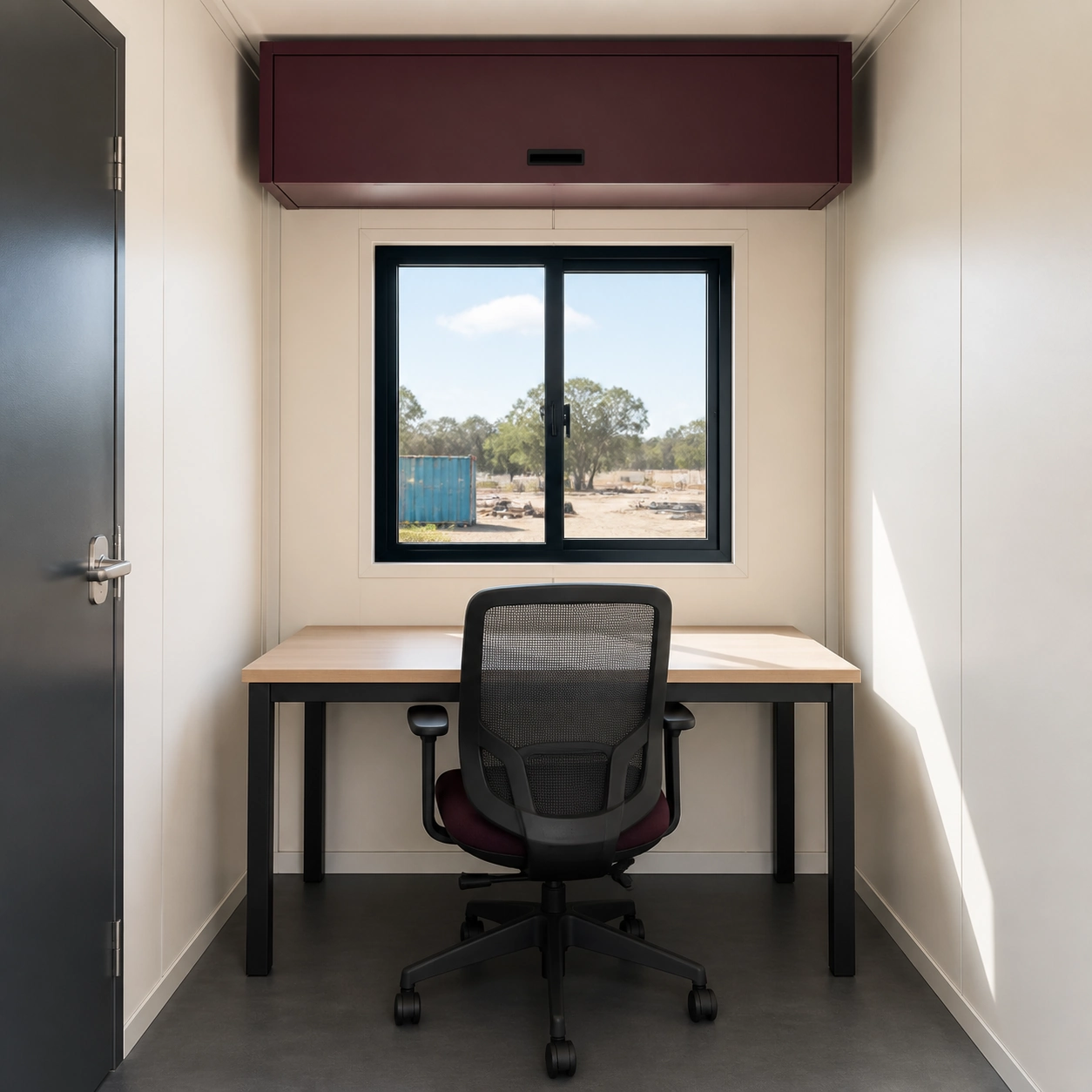 Single end workstation with desk, task chair and one overhead cabinet below a centred sliding window