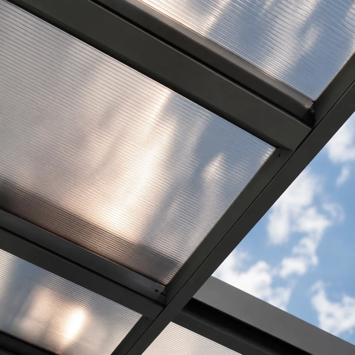 Solid polycarbonate roofing sheet fixed on a pergola frame