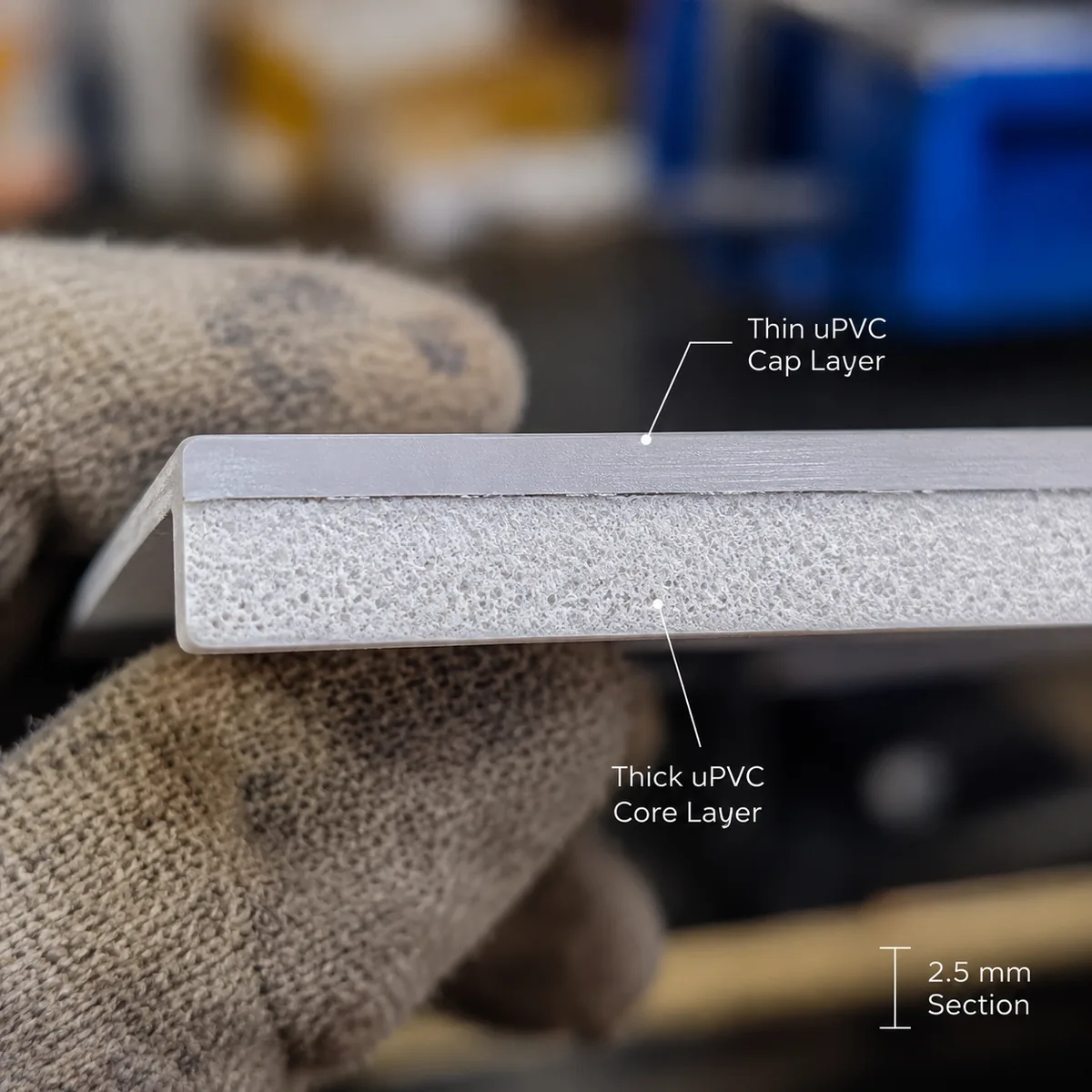 Cut edge of a multi-layer uPVC roofing sheet showing the ASA cap layer Cut edge of a multi-layer uPVC roofing sheet showing the ASA cap layer