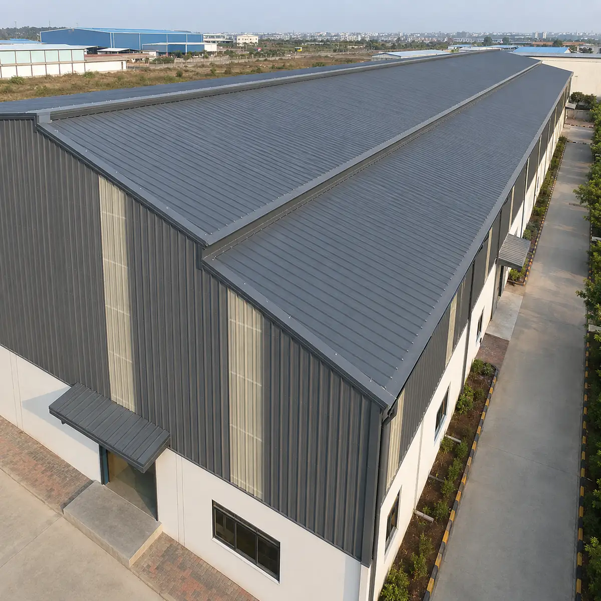 Trapezoidal colour-coated roofing sheets installed on a warehouse roof Trapezoidal colour-coated roofing sheets installed on a warehouse roof