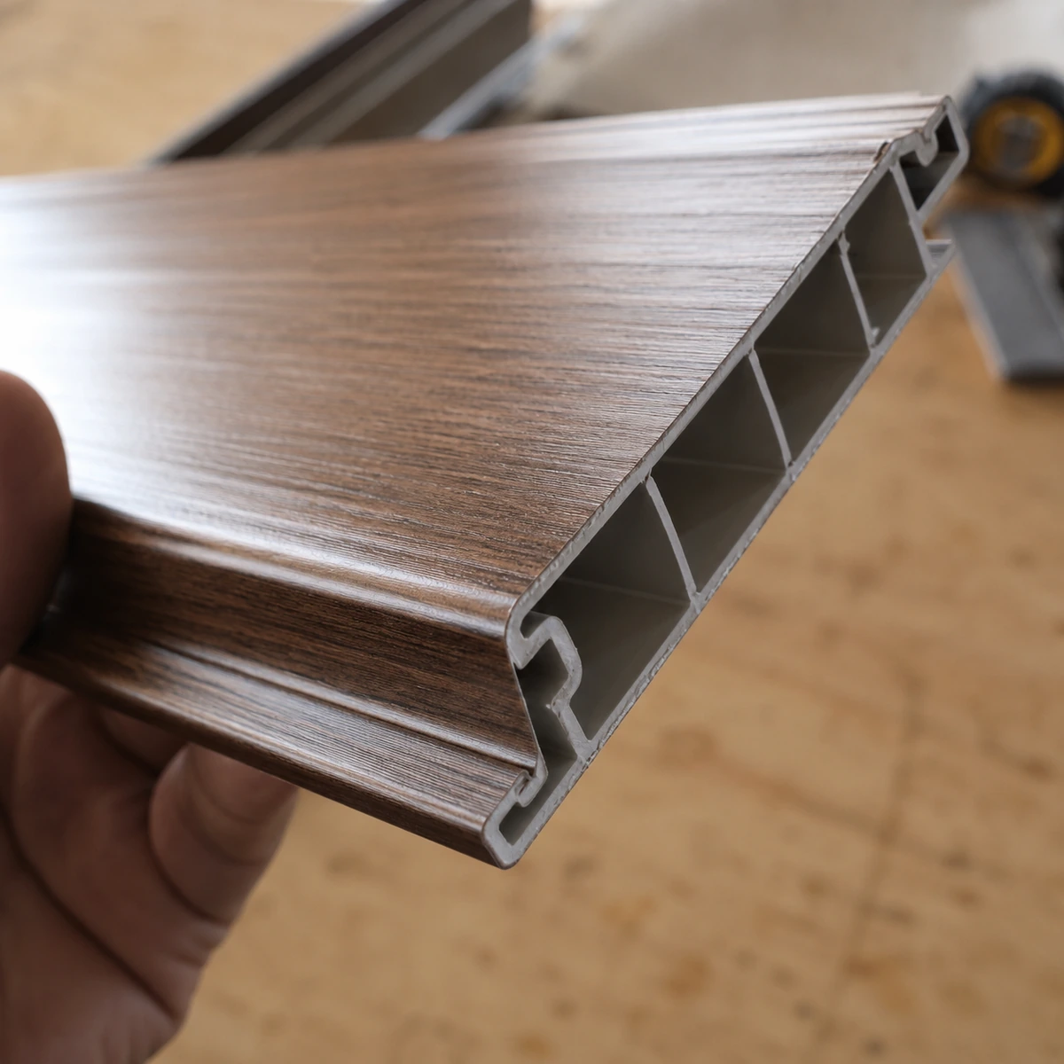 Cut edge of a hollow PVC wall panel showing cellular ribs and interlock Cut edge of a hollow PVC wall panel showing cellular ribs and interlock
